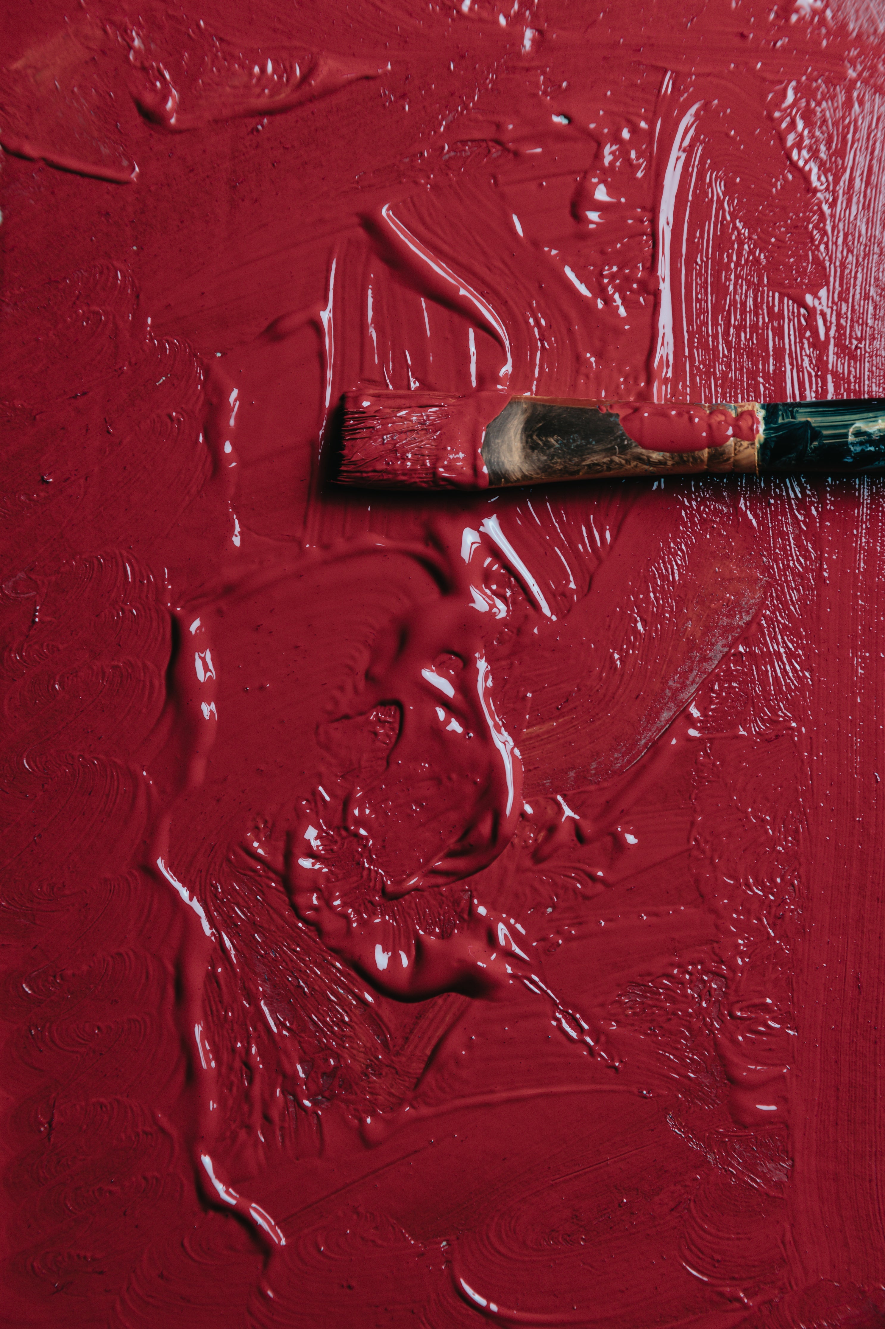 wet-red-paint-with-a-paint-brush-laying-on-it.jpg